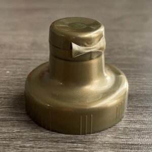 "Snap top cap on plastic bottle with golden finish"