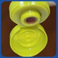 alt="Silicone valve cap with butterfly flip top for ketchup squeeze bottles"