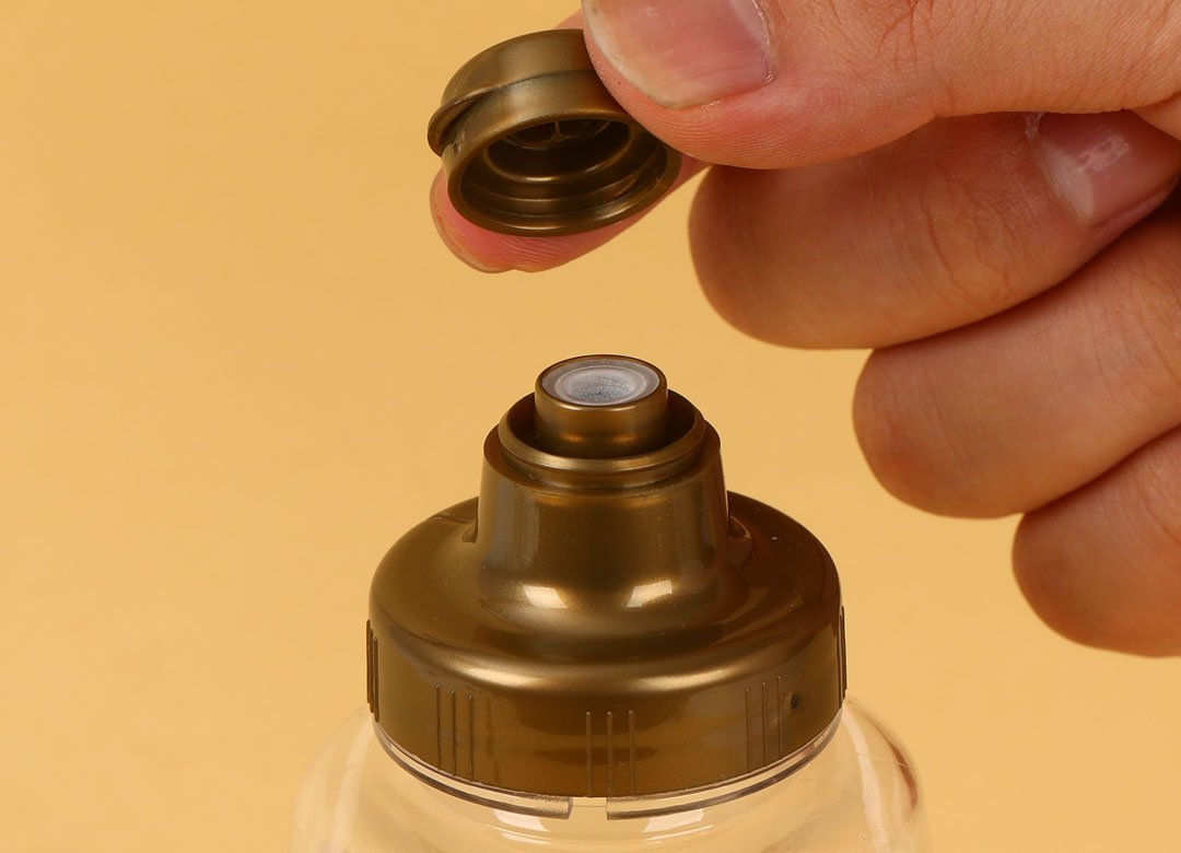 "Tampa flip top no frasco de cosméticos"