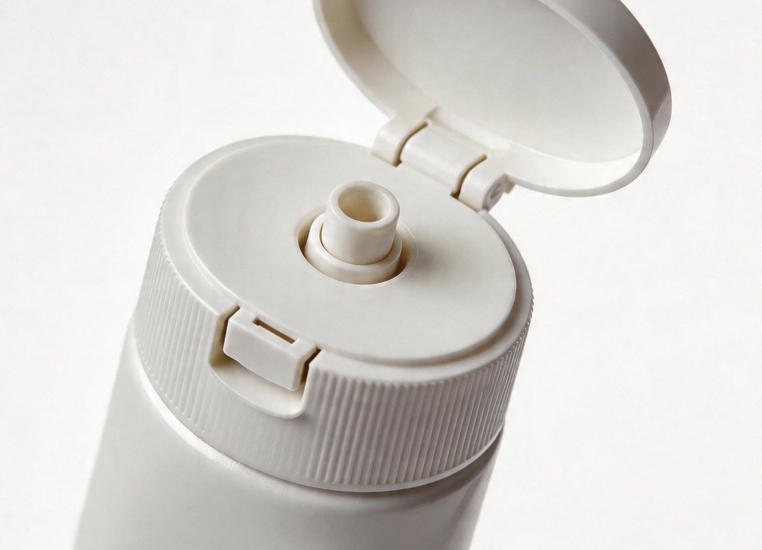 "toothpaste tube with flip top cap open"