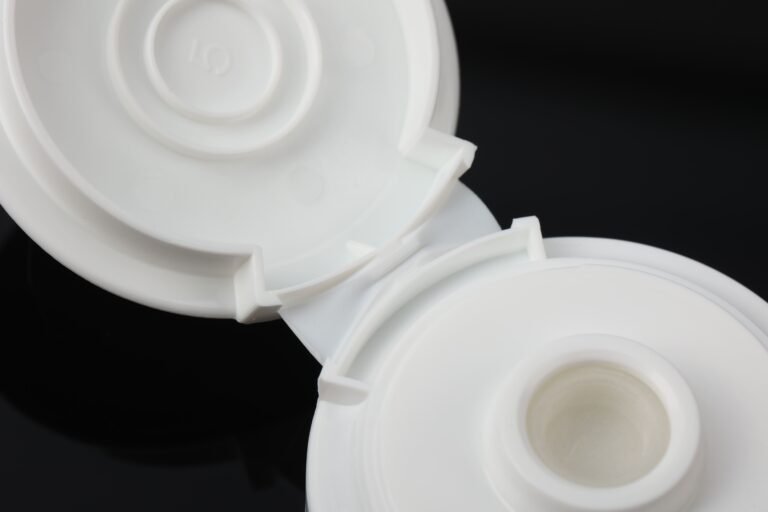 Shampoo dispensing cap with cross-slit silicone valve for inverted bottle