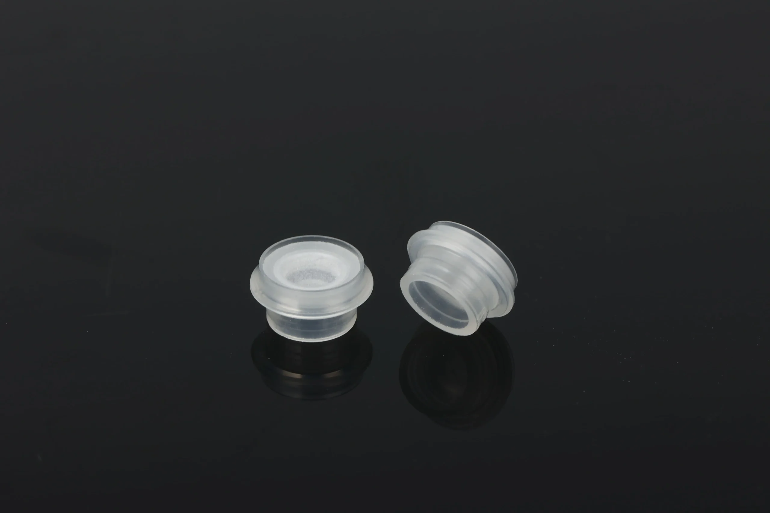 "Silicone valve components for bottle caps before assembly"