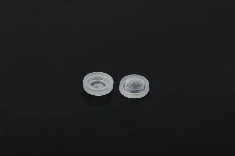 "Silicone valve for ketchup bottles with flip-top cap components before automated assembly"